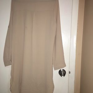 a creamlong sleeve dress with white beats on it